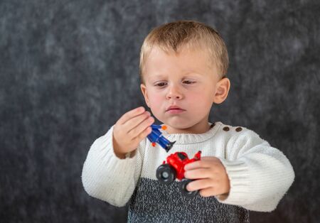 a portrait of child two years old playing