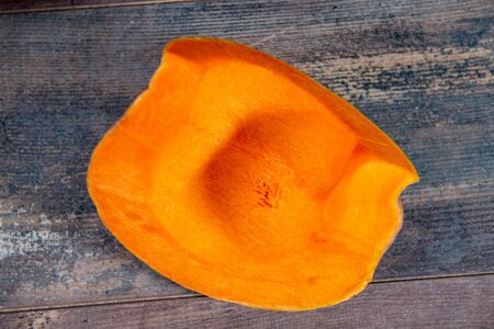 a piece of pumpkin on a wooden backgroundの写真素材