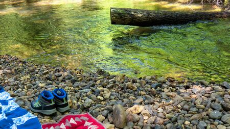Hiking shoes of a hiker on a rock