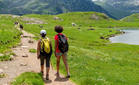 Two hiker women in the path of the french Pyrenees mountainsの写真素材