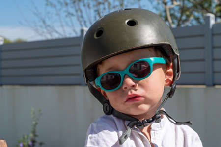 a Close up image of cute small kid wearing plastic helmet