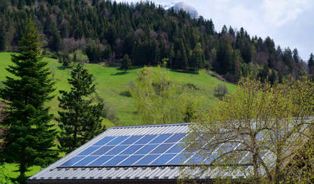 solar panels on the roof of a mountain chalet, Alps