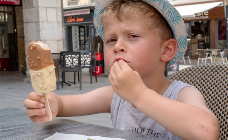 a sweet little child, boy, eating ice cream