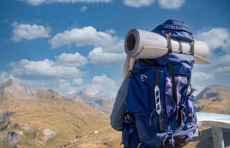hiker woman in mountains, a back viewの写真素材