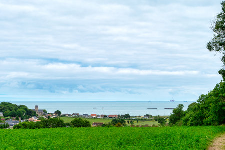 A beautiful view of a small town with the sea in the background. The sky is cloudy, but the overall...