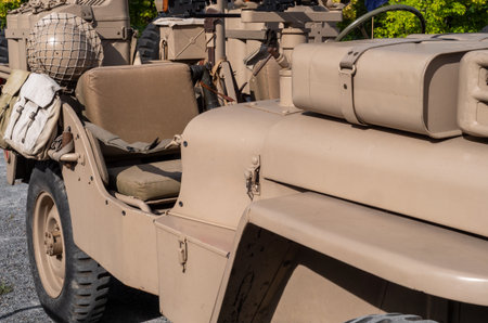 Tan jeep with a brown seat and a tan trunk. The trunk has a black strap on itの写真素材