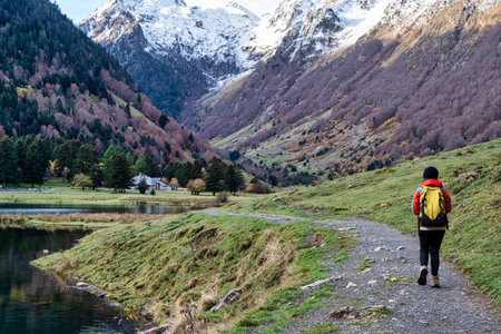 A hiker walks along Lake Estaing, Franceの写真素材