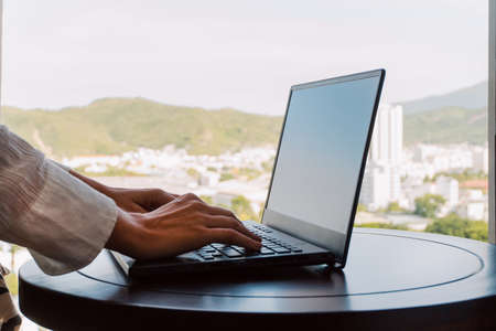 Businessman working on laptop computer with blank screen for your text.の写真素材