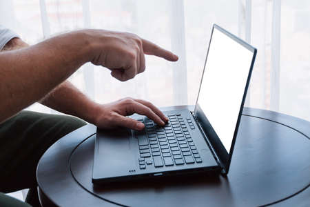 Close-up Of A Man's Hand Using Laptop At Home