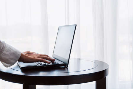 Close-up Of A Businesswoman Working On Laptop At Desk