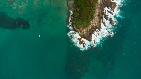 Aerial view of beautiful beach with turquoise water and cliffs