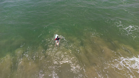 Aerial view of a surfer in the sea. Top view