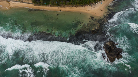 Aerial view of beautiful tropical beach with turquoise water and rocksの写真素材