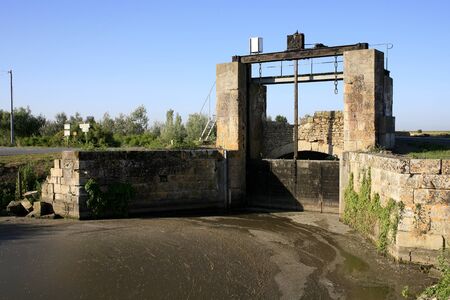 Dam on a canal in the marsh poitevinの写真素材