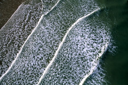 Aerial view of waves of smoke on an Atlantic beachの写真素材