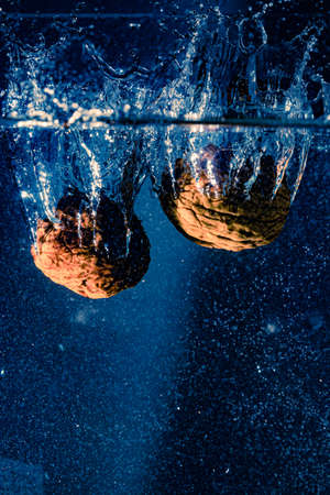 walnuts falling in water