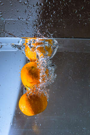 Corsican clementines thrown into waterの写真素材