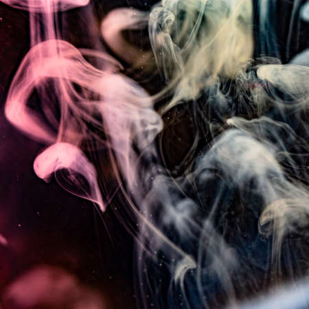 cloud of milk in water with colorful backgroundの写真素材