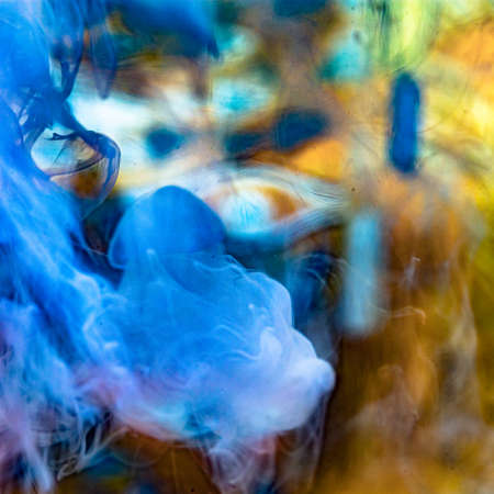 cloud of milk in water with colorful backgroundの写真素材