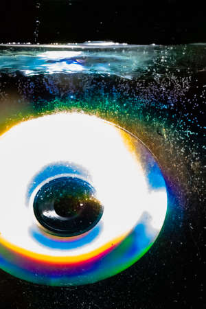 compact disc thrown into waterの写真素材