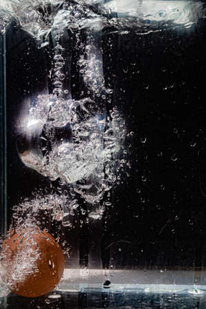 egg falling into waterの写真素材