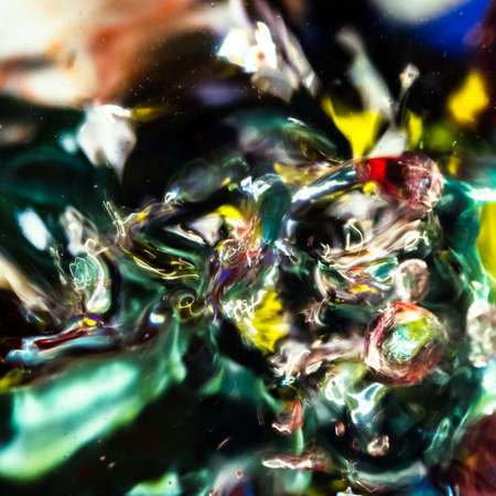 watercolor drops in a glass of water, close upの写真素材