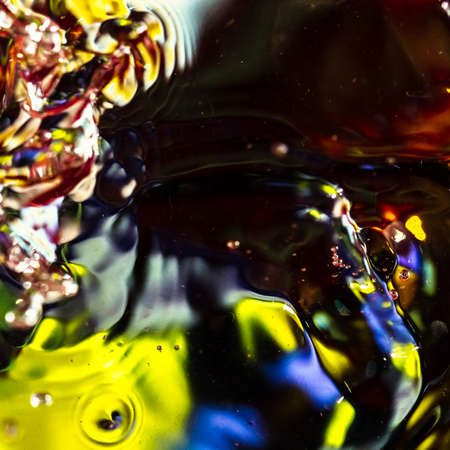 watercolor drops in a glass of water, close upの写真素材