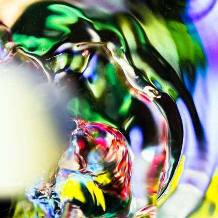 watercolor drops in a glass of water, close upの写真素材