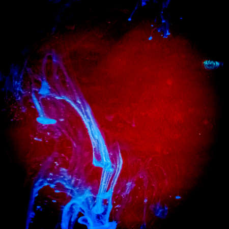 watercolor drops in a glass of water, close upの写真素材