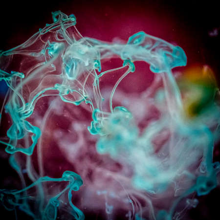 watercolor drops in a glass of water, close up