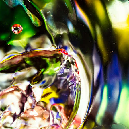 watercolor drops in a glass of water, close upの写真素材