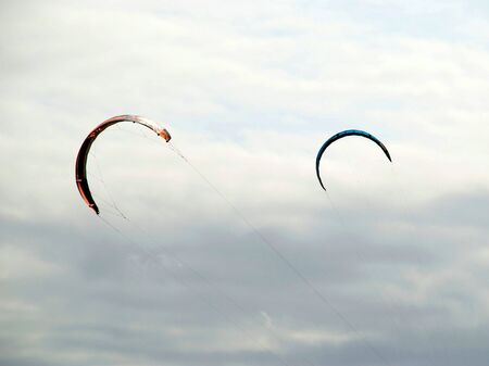 Two kiteboarding kites against cloudy skyの写真素材