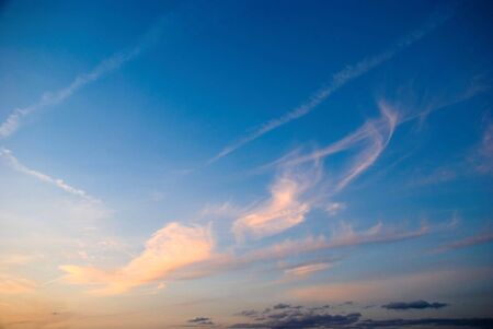Pink clouds against blue sky at sunsetの写真素材
