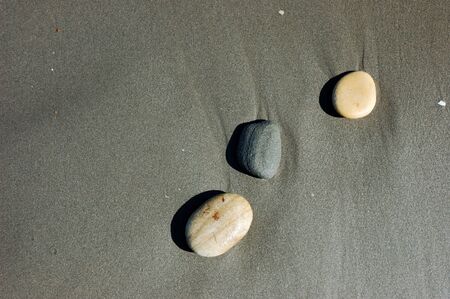 Three stones on the beachの写真素材