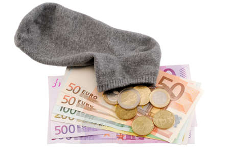 Saving euro money in the sock, isolated over white backgroundの写真素材