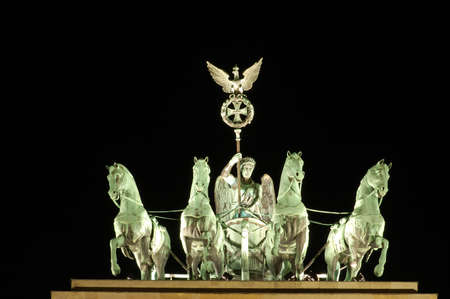 Quadriga on Top of Brandenburger Gate in Berlin, Germany, illuminated at Nightの写真素材
