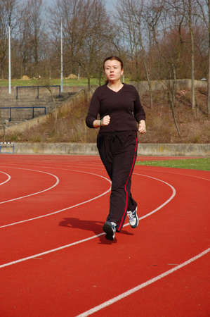 Teenage Girl Jogging in a Stadium