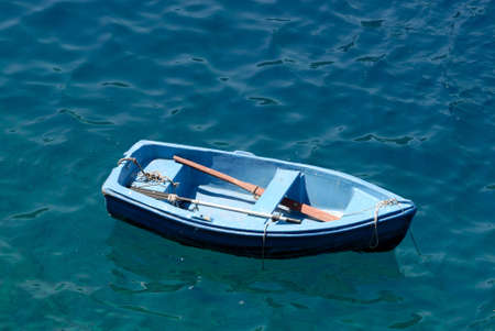 Rowboat in blue water, Santorini Greeceの写真素材
