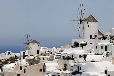 Two traditional windmills in Oia, island Santorini Greeceの写真素材
