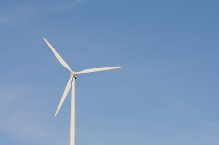 Wind turbine against blue skyの写真素材