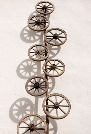 Old wooden wheels on the wall