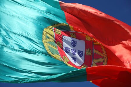 Portuguese Flag against blue skyの写真素材