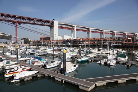 Marina in Lisbon, Portugal. The 25 de Abril Bridge in the background. Photo taken at 26 June 2010のeditorial素材