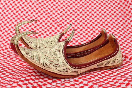 Traditional oriental shoes over arabic clothの写真素材