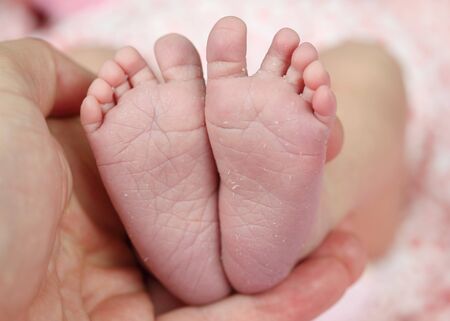 Tiny feet of a newborn baby