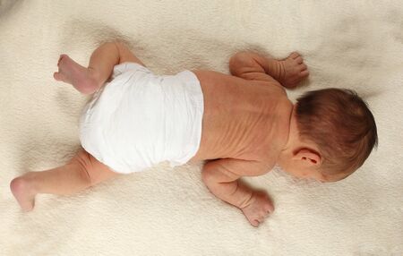 Cute newborn baby girl on white blanketの写真素材
