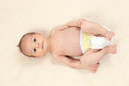 Cute little baby girl lying on bed