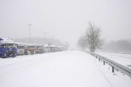Trucks on a parking place on a German Autobahn in winter. Photo taken at 20th of December 2009のeditorial素材