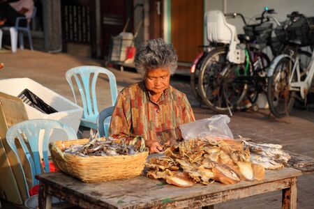 Woman selling dried fish at street market in Cheung Chau, Hong Kong. Photo taken at 3rd of December 2010のeditorial素材