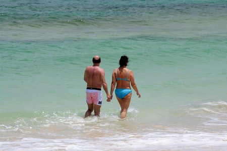 Elderly couple walking in the surf, Canary Island Fuerteventura, Spain. Photo taken at 27th of May 2009のeditorial素材